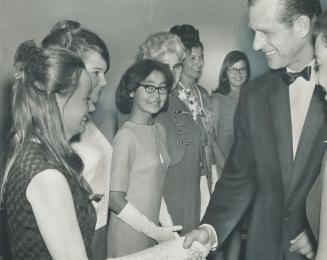 Prince Philip Meets The Ladies, Glenna Graham (right) YWCA program director for Canada, watches Prince Philip shake hands with Marni Churchill at YWCA annual meeting yesterday