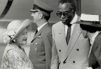 Warm greeting: Queen Elizabeth the Queen Mother arrives at Pearson International Airport last night to be met by Lieutenant-Governor Lincoln Alexander and his wife Yvonne