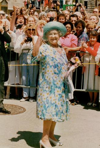 The Queen Mom stops and gives a wave and a smile to the crowd who waited for 2 hours