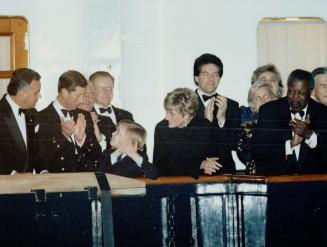 Royal Applause: Prince William is flanked by parents Charles and Diana on the royal yacht Britannia last night as he applauds musicians ashore