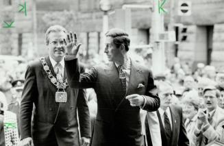 Toronto Mayor Art Eggleton follows as Prince Charles waves to crowd in Nathan Phillips Square today