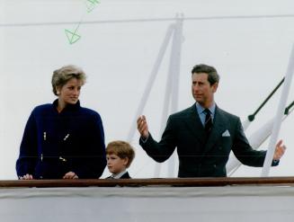 A frustrated Prince Charles awaits his elder son William on Britannia's top deck yesterday