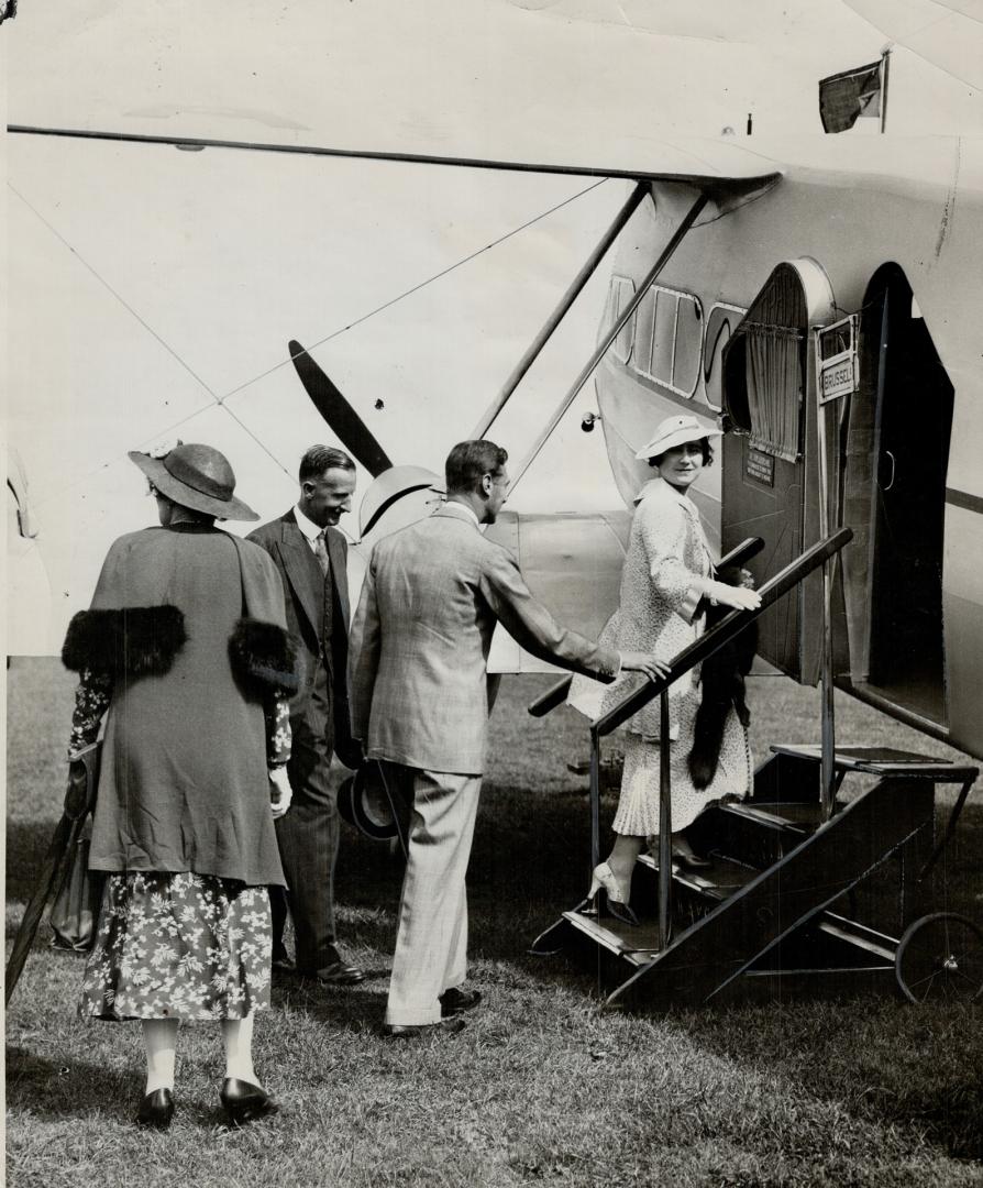 Duchess of York's first aeroplane flight-The Duke and Duchess of York entering an Imperial Airways aeroplane at Hendon, England for a flight to Brussels