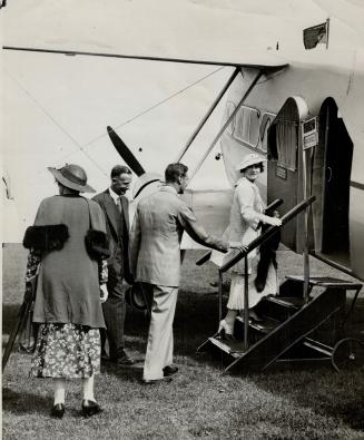 Duchess of York's first aeroplane flight-The Duke and Duchess of York entering an Imperial Airways aeroplane at Hendon, England for a flight to Brussels