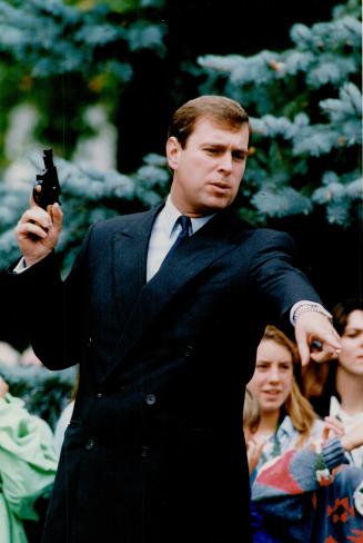 Prince Andrew shows good form yesterday as he cocks a starter's pistol for a cross-country run at Lakefield College's homecoming, which he attended to launch a $6 million fundraising drive