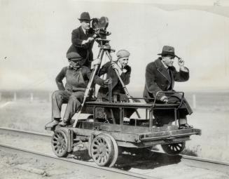 With his camera mounted on a speed official newsreel cameraman, Tracy Mathewson, follows the royal train, making pictures of Edward VIII on the observ(...)