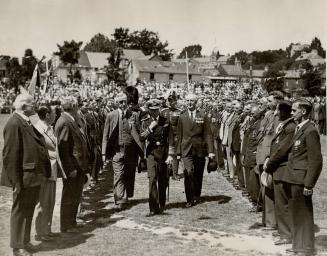 Photo shows the Prince of Wales inspecting ex-Servicemen at Victoria College playing fields, on his arrival at Jersey
