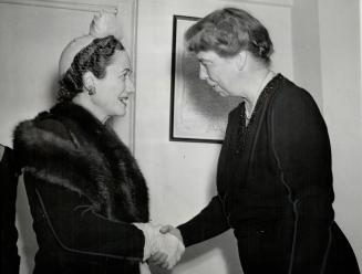 Greetings are exchanged by the Duchess of Windsor (Left) and Mrs