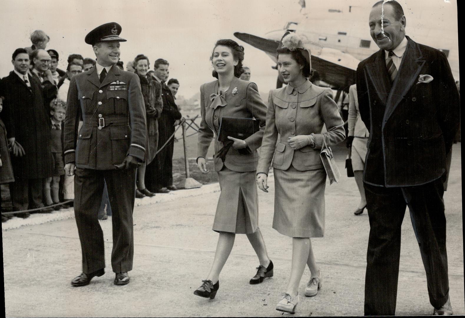 Princess Margaret is met by her betrothed sister, Princess Elizabeth, at London airport after the former had flown back from Northern Ireland launching of the new liner Edinburgh Castle