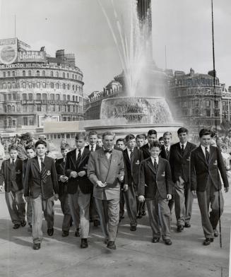Crossing famed Trafalgar Square in London are boys of the Appleby college boy's choir, Oakville, Ont