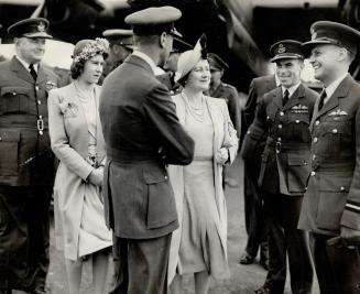 The King and Queen and Princess Elizabeth are shown visiting a bomber station of the R