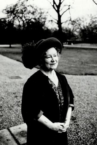HRH Queen Elizabeth, the Queen Mother stands before the driveway to Clarence House
