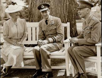 In a restful moment in the garden at Rideau Hall, Ottawa, the Duke of Kent is photographed with Princess Alice and his excellency, the Earl of Athlone, governor general of Canada