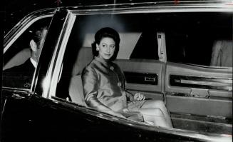 Off to dinner party, at the home of Mrs. Egmont Frankel, Princess Margaret leaves the Royal York Hotel by car last night. Mrs. Frankel is honorary cha(...)