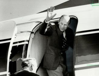 Prince Philip waves goodbye before boarding his plane today at Pearson International Airport and is seen a few minutes later at the controls of the tu(...)