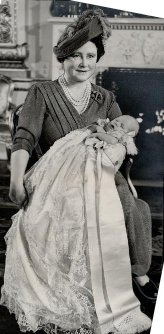 Happy Grandmother of the infant prince, Queen Elizabeth has her turn at holding the beloved bundle following christening ceremony at which the King insisted on standing