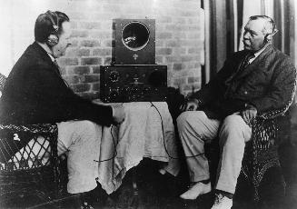 Arthur Conan Doyle listening to radio with F