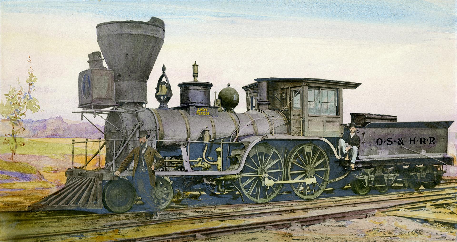 Image shows a steam locomotive on tracks.