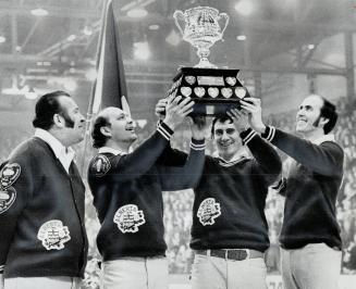 Hec Gervais beams his approval as other members of Alberta rink hoist the Macdonald's Brier Tankard following their 4-2 win over Quebec, skipped by Ji(...)