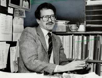 Richard Gilbert at work in his tiny City Hall office