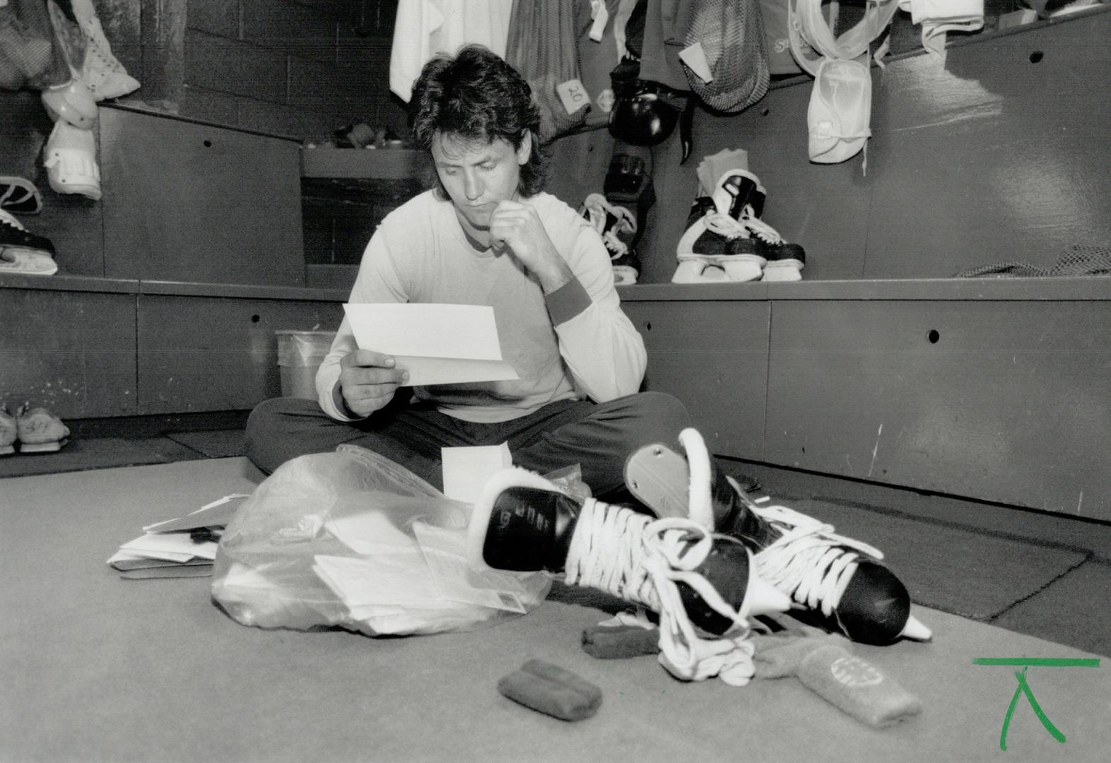 Fan mail: Maple Leafs centre Doug Gilmour catches up on some of his mail yesterday at the team's first practice since the NHL players went on strike