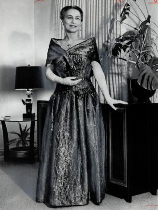Mrs. Philip Givens in antique green India silk brocade gown and jade jewelry chosen for Monday's royal dinner party