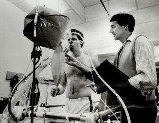 Fitness-testing: Dr. Norman Gledhill of York University tests the amount of oxygen used by runner John McKee, 20, as part of his sports medicine resea(...)