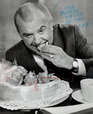 Elwood Glover, celebrating 30 years with the CBC yesterday, digs into his anniversary cake on Luncheon Date, his noon hour TV interview show, Suave an(...)