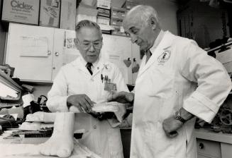 Custom shoe lab: Dr. Charles Godfrey, physiatrist-in-chief at Wellesley Hospital, right, is shown in the hospital's shoe store chatting with pedorthis(...)