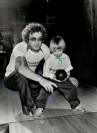 Father and son. Noah Godfrey, 3-year-old son of. Metro Chairman Paul Godfrey, tries for a strike against leukemia as his father coaches him. Godfrey a(...)