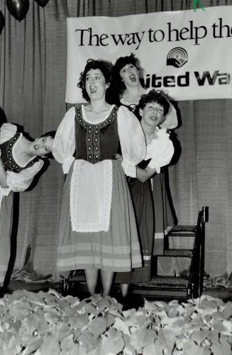A song in their heart: United Way president Anne Golden, middle, is among entertainers at the end-of-campaign dinner at the Sheraton Centre
