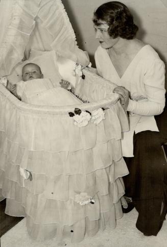 Mrs E. H. Gooderham of Toronto and her infant son, Edward Douglas. Mrs Gooderham is the former Cecil Eustace Smith, well-known champion figure skater