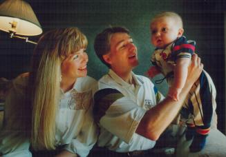 A refuge from racing: New Canadian star Scott Goodyear, with his wife, Leslie, proudly hoids up his 4-month-old son, Christopher