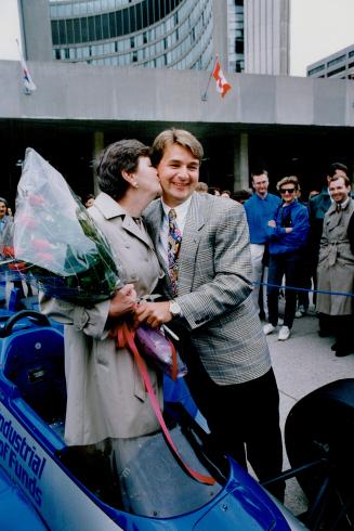 Proud Mom: Indy 500 racer Scott Goodyear gets kiss from his mother during reception at Toronto City Hall