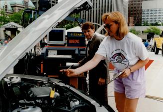 IndyCar driver Scott Goodyear helps Environment Canada's Vera Ballantyne promote vehicle emissions tests earlier this summer