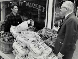 Liberal Walter Gordon chats with Davenport riding vegetable store manager Benito Cimicata