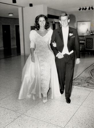 Below, getting ready to make their first entrance as a newly married couple are Rebecca Grafstein in a wedding grown of white silk and lace by Milli of Hamilton, and Laurence Grafstein