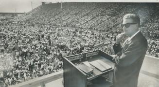 Billy Graham, left, leading a crusade in the CNE grandstand