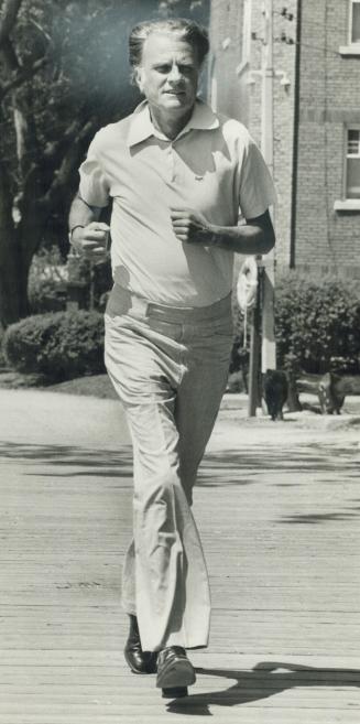 Boardwalk jogger: Rev. Billy Graham keeps in shape during his Toronto crusade. Now 59, he has been preaching for 35 years and despite fame is a man of(...)