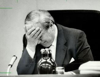 Day of frustration: Mr. Justice Samuel Grange, burying his head in his hands, suspended hearings into baby deaths