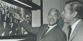 Old class photo draws grin from Lorne Greene (left) as he jokes with TV personality Fred Davis about moustache Davis was sporting in a 1947 photo of s(...)