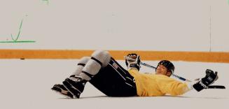 Lying Down on the Job: King Wayne Gretzky clowns for teammates and the assembled press hordes during practice yesterday at the Gardens