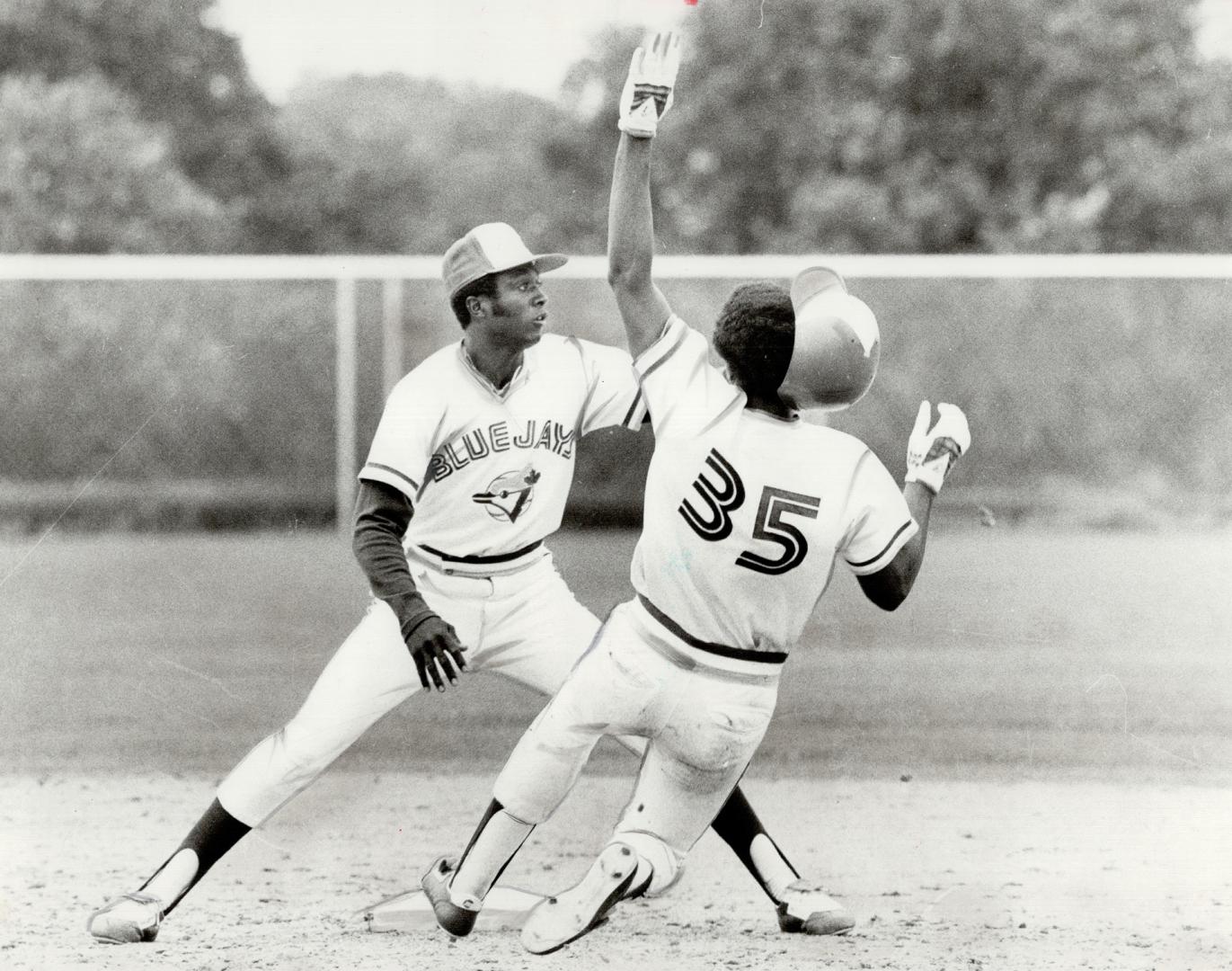 It's rookie against rookie as shortstop Alfredo Griffin takes throw to catch Ted Wilborn