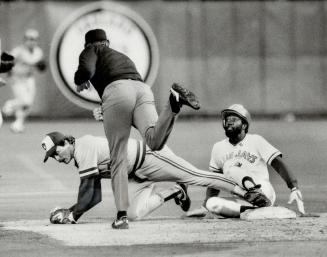 What do you mean I'm out? Jays' Alfredo Griffin looks disbelievingly as ump Mike Reilly after he was called out at second base. Brewers' Jim Gantner t(...)