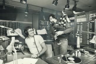 Lord knows what there is to laugh about at the unearthly hour of 7 o'clock in the morning, but CHUM-FM radio's Peter Griffin (left) and Geets Romo (Da(...)