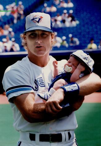 Handy Man: Kelly Gruber holds infant son Kody in one hand and smacks a  single with the other in Blue Jays' annual father-kids game yesterday – All  Items – Digital Archive 
