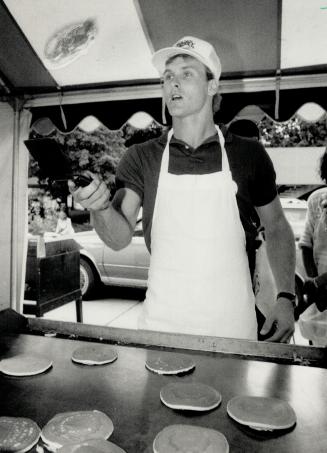 Batter up for pancake brunch. Toronto Blue third baseman Kelly Gruber (left) flips pancakes yesterday at a noontime brunch at Nathan Phllips Square to(...)