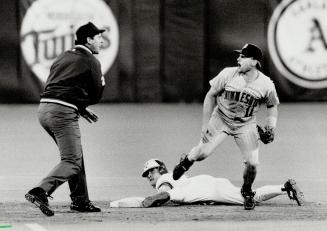 Say what! Twins second baseman Chuck Knoblauch wasn't exactly in agreement with the ump's call as Kelly Gruber slid safely into second