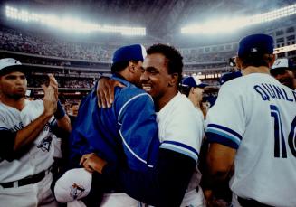 Hugging the hero: Blue Jays manager Cito Gaston embraces smiling Juan Guzman after the pitcher's fine work led his team to victory over the Tigers