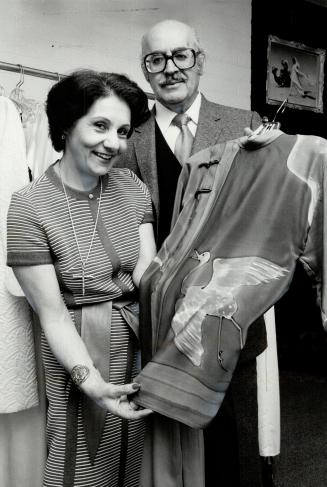 Harsh words: Al and Claire Haddad, pictured here with fabric handpainted by a Canadian artist on silk crepe de chine, say Canadian textile manufacturers aren't competing on an international scale